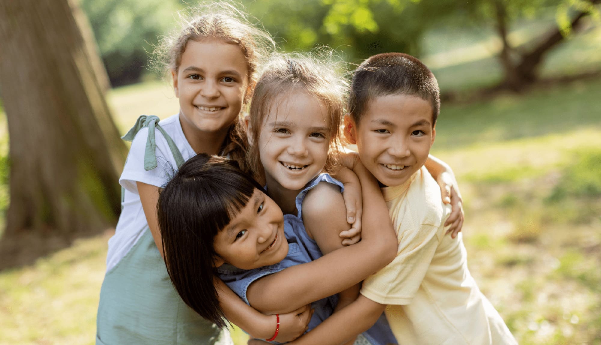Group of asian and caucasian kids having fun in the park
