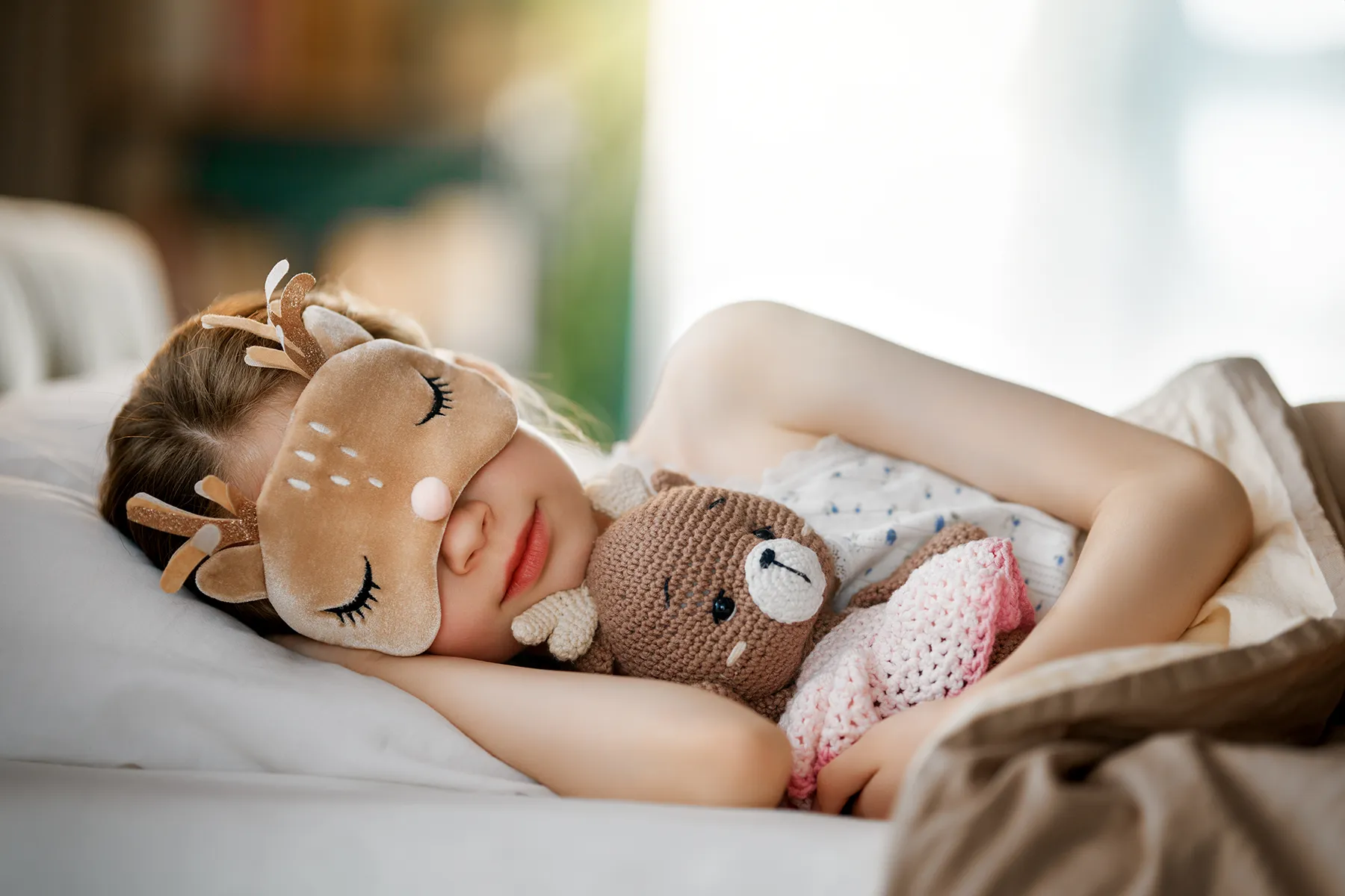 child is sleeping in the bed